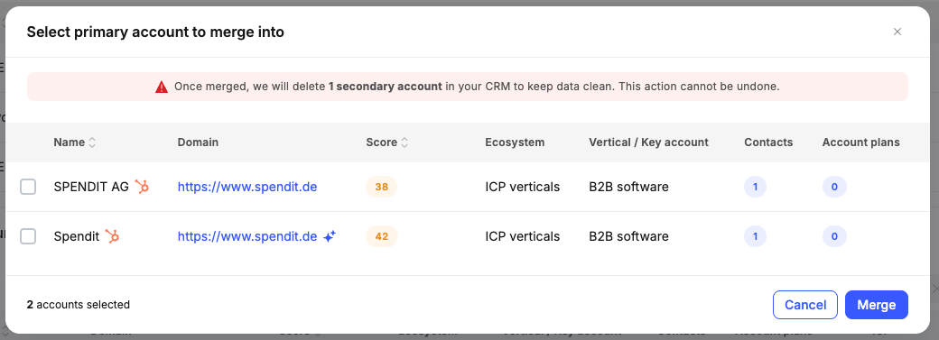 Select primary account to merge into modal, with a clear warning that the secondary record will be deleted in the CRM